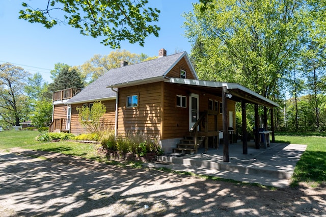 10465 Range Line Rd, Berrien Springs, MI 49103 - view of front of house with a chimney, roof with shingles, and a front lawn