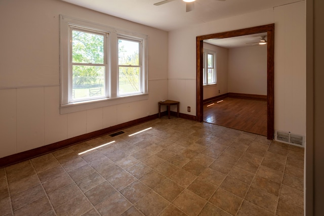 10465 Range Line Rd, Berrien Springs, MI 49103 - spare room with a ceiling fan, wainscoting, and baseboards
