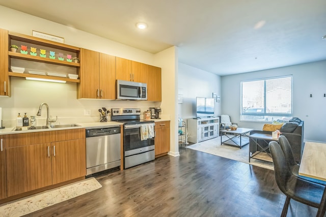 630 S Garfield Ave Unit 107, Traverse City, MI 49686 - kitchen with stainless steel appliances, a sink, dark wood-type flooring, and light countertops