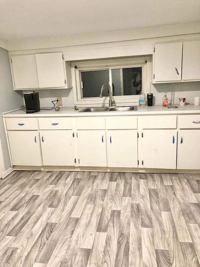 4127 Coggins Ave, Flint, MI 48506 - kitchen with a sink, light countertops, and white cabinets