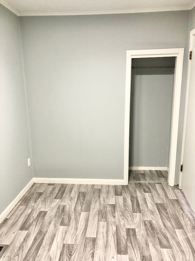 4127 Coggins Ave, Flint, MI 48506 - unfurnished bedroom featuring wood finished floors, baseboards, and crown molding