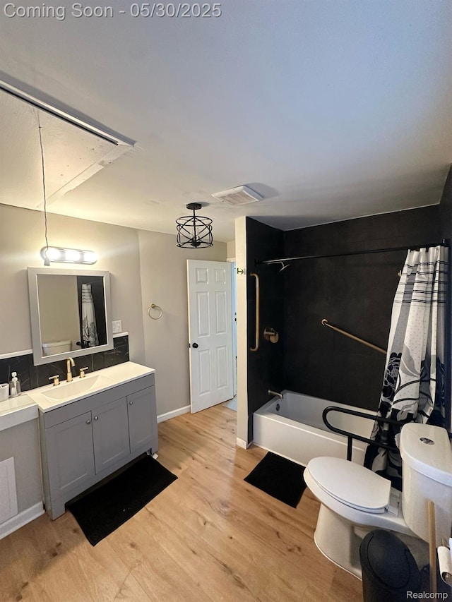 1228 E Jarvis Ave, Hazel Park, MI 48030 - full bath with wood finished floors, toilet, shower / tub combo, vanity, and baseboards