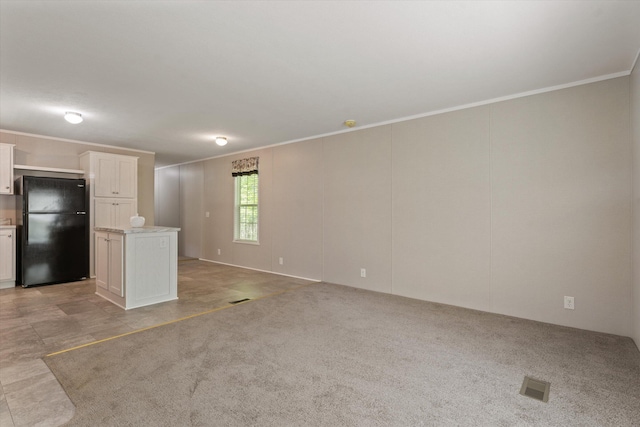 16747 Williamsville St, Vandalia, MI 49095 - unfurnished living room featuring crown molding and light colored carpet