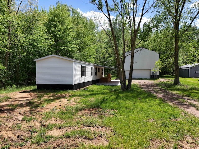 16747 Williamsville St, Vandalia, MI 49095 - view of front of property featuring an outbuilding, a detached garage, and a front lawn