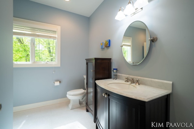 3099 Pickford Dr SE, Ada, MI 49301 - bathroom with toilet, vanity, and baseboards