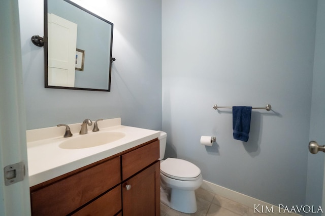 3099 Pickford Dr SE, Ada, MI 49301 - half bathroom with vanity, toilet, tile patterned flooring, and baseboards