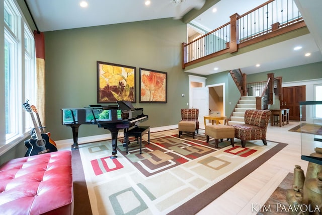 3099 Pickford Dr SE, Ada, MI 49301 - living area featuring high vaulted ceiling, plenty of natural light, stairs, beamed ceiling, and recessed lighting