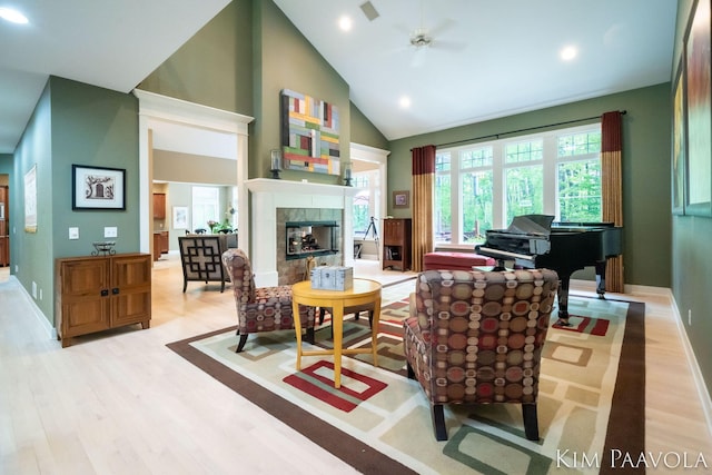3099 Pickford Dr SE, Ada, MI 49301 - living room featuring wood finished floors, a tile fireplace, a ceiling fan, recessed lighting, and high vaulted ceiling