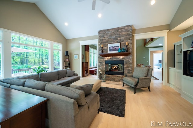 3099 Pickford Dr SE, Ada, MI 49301 - living area featuring a fireplace, a ceiling fan, light wood-style floors, high vaulted ceiling, and recessed lighting