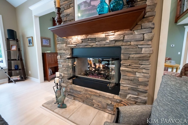 3099 Pickford Dr SE, Ada, MI 49301 - detailed view of a fireplace, wood finished floors, and baseboards