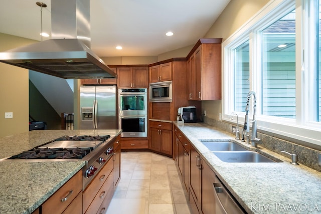 3099 Pickford Dr SE, Ada, MI 49301 - kitchen with appliances with stainless steel finishes, island range hood, a sink, brown cabinets, and light stone countertops