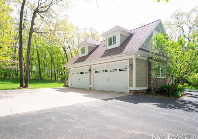 3099 Pickford Dr SE, Ada, MI 49301 - view of side of property with driveway, roof with shingles, and a garage