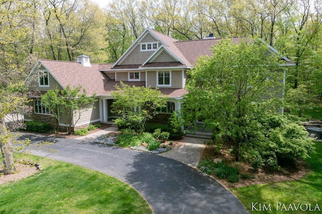 3099 Pickford Dr SE, Ada, MI 49301 - view of front of home featuring a chimney and roof with shingles