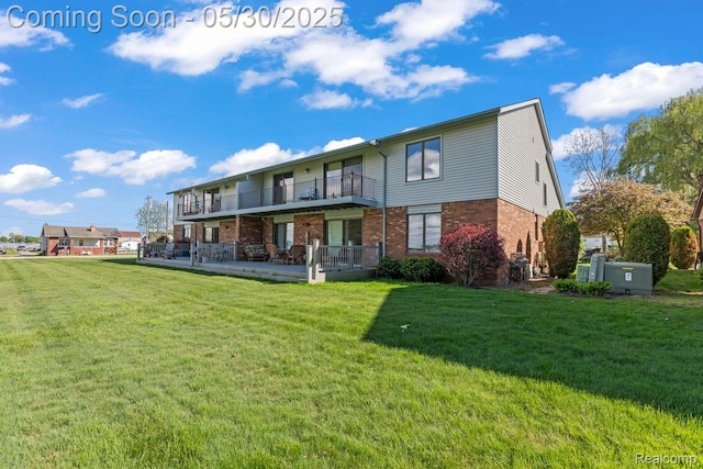 9200 River Rd Unit 3, Clay, MI 48001 - rear view of property with a balcony, brick siding, and a lawn