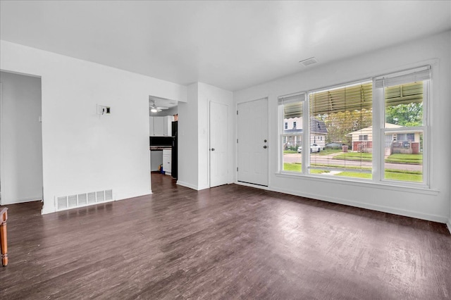 228 Hughes Ave, Pontiac, MI 48341 - unfurnished living room with dark wood finished floors and baseboards