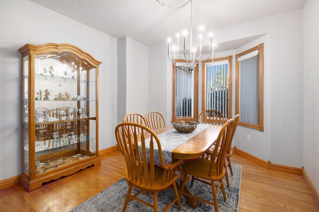 2512 Misty Ln, Davison, MI 48423 - dining area with a chandelier, light wood-style flooring, and baseboards