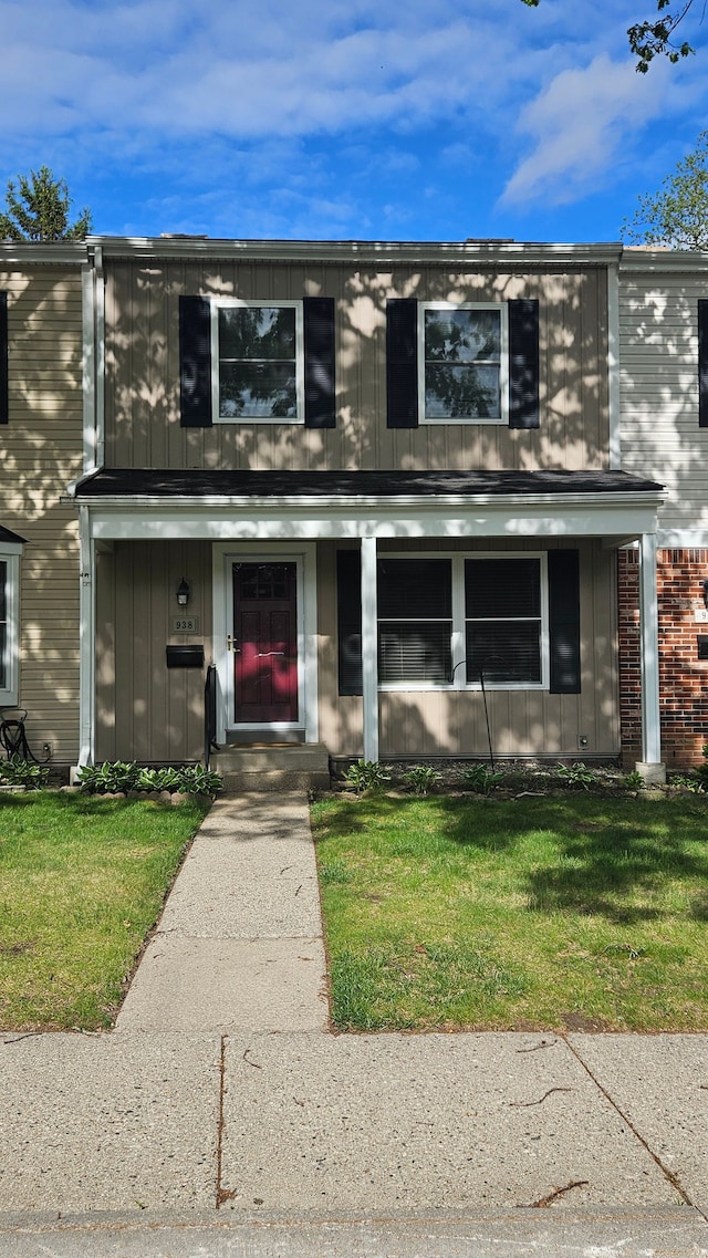 938 Little Hill Ct, Rochester Hills, MI 48307 - view of front of property featuring a front yard, board and batten siding, and brick siding