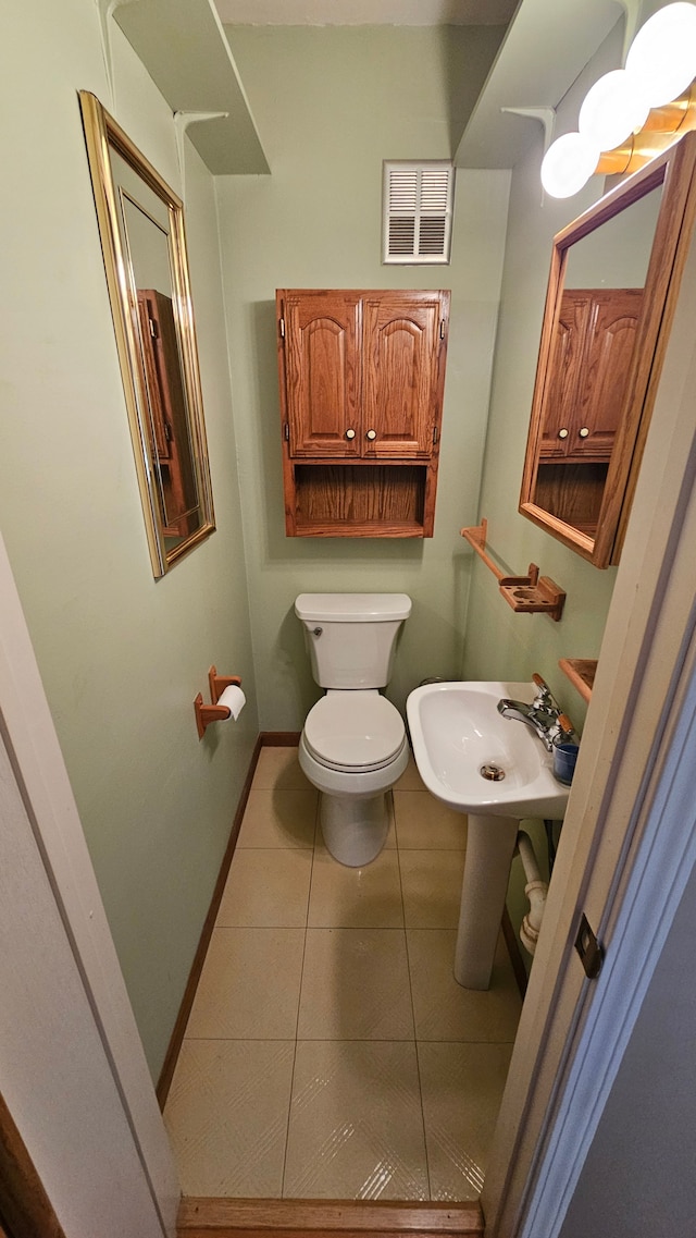 938 Little Hill Ct, Rochester Hills, MI 48307 - half bath featuring tile patterned flooring, toilet, a sink, and baseboards
