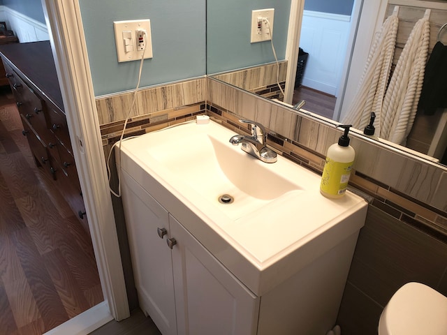 15701 Middlebelt Rd, Romulus, MI 48174 - bathroom with vanity, toilet, and wainscoting
