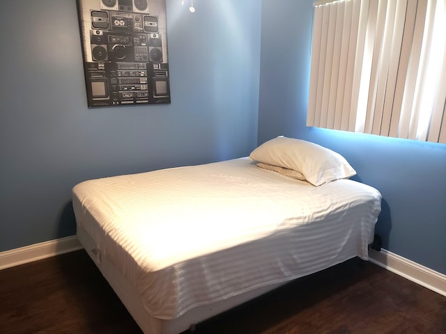15701 Middlebelt Rd, Romulus, MI 48174 - bedroom with baseboards and wood finished floors
