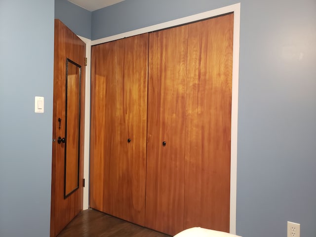 15701 Middlebelt Rd, Romulus, MI 48174 - unfurnished bedroom featuring a closet and dark wood-type flooring