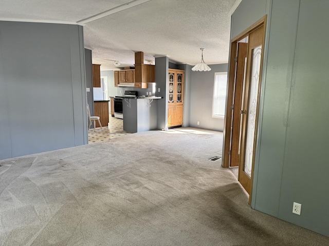 829 Savannah River Dr Unit 82, Adrian, MI 49221 - unfurnished living room with light carpet, a chandelier, and a textured ceiling