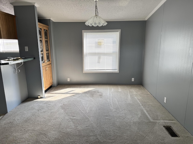 829 Savannah River Dr Unit 82, Adrian, MI 49221 - unfurnished dining area featuring crown molding, light colored carpet, and a textured ceiling