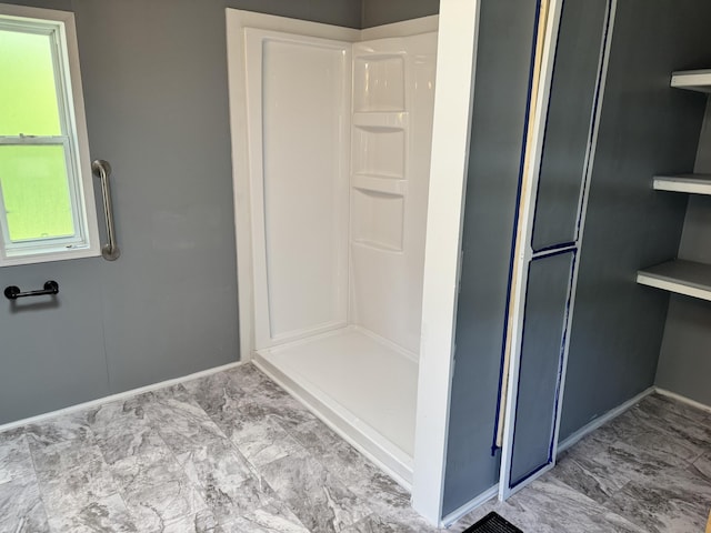 829 Savannah River Dr Unit 82, Adrian, MI 49221 - bathroom featuring a shower, baseboards, and marble look tile flooring