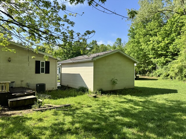 829 Savannah River Dr Unit 82, Adrian, MI 49221 - view of grassy yard featuring central AC unit and an outdoor structure