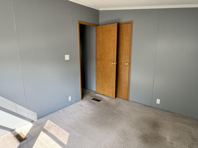 829 Savannah River Dr Unit 82, Adrian, MI 49221 - unfurnished bedroom with crown molding, carpet floors, and a textured ceiling