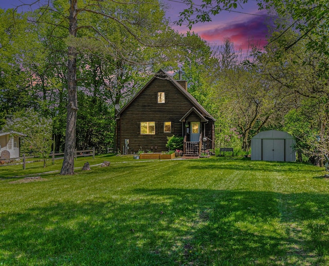 18862 Oxbow Dr, Barryton, MI 49305 - view of front of home with a chimney, a shed, a lawn, and an outdoor structure