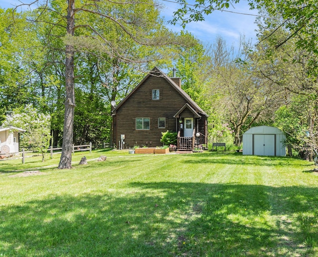 18862 Oxbow Dr, Barryton, MI 49305 - rear view of house featuring a shed, a chimney, and an outbuilding