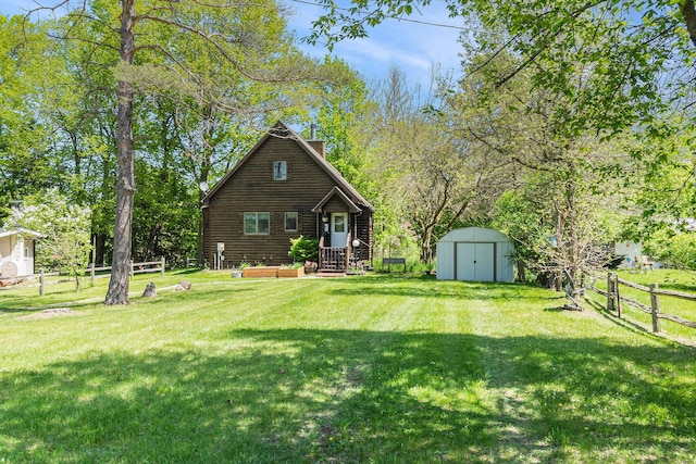 18862 Oxbow Dr, Barryton, MI 49305 - rear view of property featuring a storage shed, a chimney, and an outdoor structure