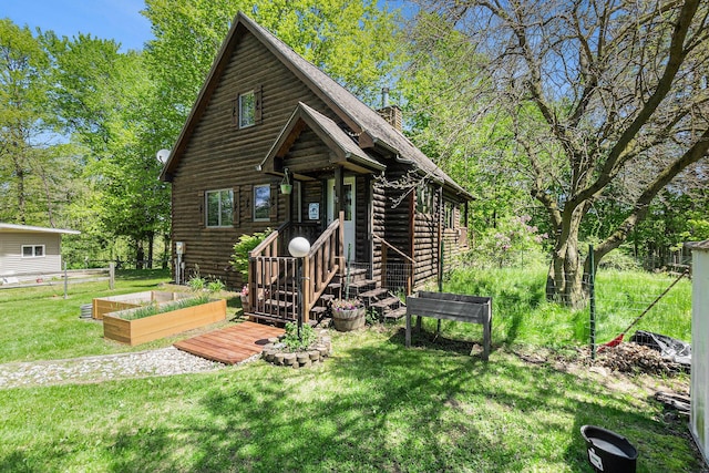 18862 Oxbow Dr, Barryton, MI 49305 - log home featuring a garden, a front yard, log exterior, and a chimney