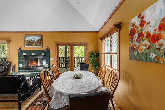 18862 Oxbow Dr, Barryton, MI 49305 - dining area featuring a tile fireplace, plenty of natural light, wood finished floors, and high vaulted ceiling