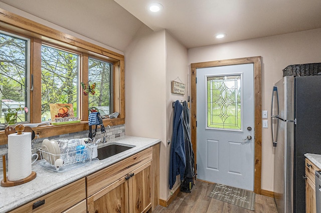 18862 Oxbow Dr, Barryton, MI 49305 - kitchen with freestanding refrigerator, light wood-type flooring, a sink, light countertops, and baseboards