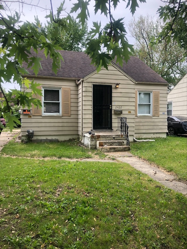 2422 Missouri Ave, Flint, MI 48506 - bungalow featuring a front lawn and a shingled roof