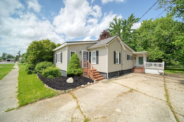 10913 E Railroad St, Clayton, MI 49235 - view of front of property featuring driveway and metal roof