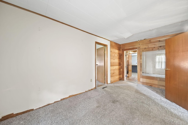 10913 E Railroad St, Clayton, MI 49235 - unfurnished bedroom with carpet flooring and wood walls