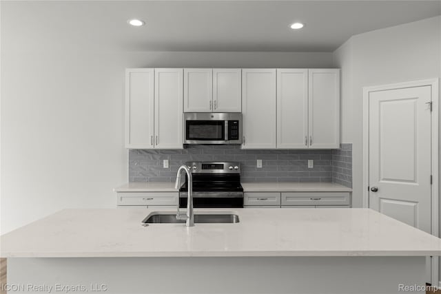 2396 Pondview Ln, Troy, MI 48085 - kitchen featuring stainless steel appliances, tasteful backsplash, light stone counters, white cabinetry, and recessed lighting