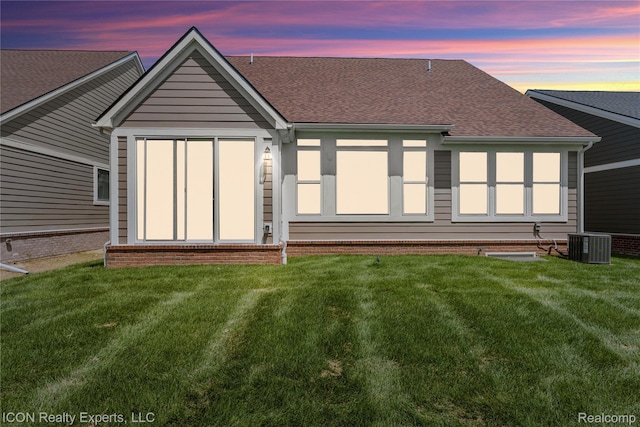2396 Pondview Ln, Troy, MI 48085 - back of house at dusk with roof with shingles and a yard