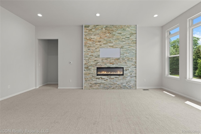 2396 Pondview Ln, Troy, MI 48085 - unfurnished living room featuring carpet floors, recessed lighting, and a fireplace