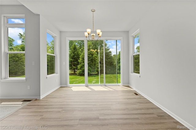 2396 Pondview Ln, Troy, MI 48085 - unfurnished dining area featuring a chandelier and wood finished floors