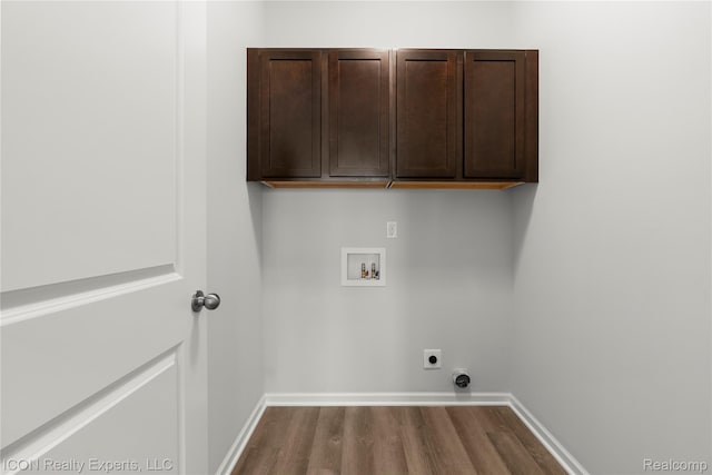 2396 Pondview Ln, Troy, MI 48085 - washroom with washer hookup, hookup for an electric dryer, dark wood finished floors, and cabinet space