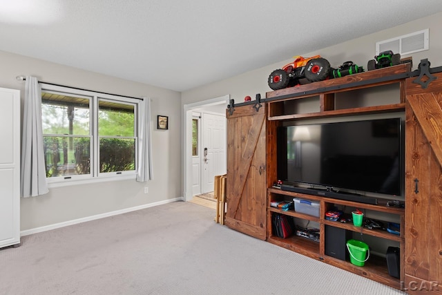 9705 Crescent Ct, Tecumseh, MI 49286 - unfurnished living room featuring a barn door, carpet floors, and baseboards