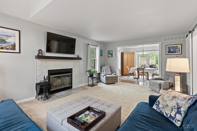 9705 Crescent Ct, Tecumseh, MI 49286 - living room featuring carpet flooring, plenty of natural light, a tiled fireplace, and a chandelier