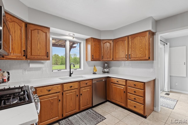 9705 Crescent Ct, Tecumseh, MI 49286 - kitchen featuring a sink, appliances with stainless steel finishes, brown cabinetry, and tasteful backsplash