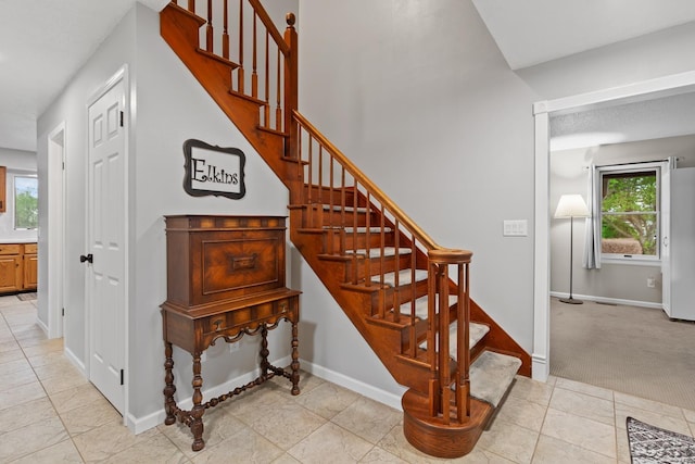 9705 Crescent Ct, Tecumseh, MI 49286 - stairway featuring baseboards and tile patterned flooring