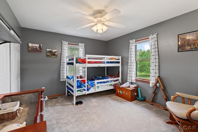 9705 Crescent Ct, Tecumseh, MI 49286 - bedroom with multiple windows, carpet, a ceiling fan, and baseboards