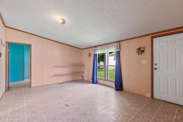 943 Howell Ave, Adrian, MI 49221 - unfurnished room featuring ornamental molding, a textured ceiling, and tile patterned flooring